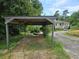 Simple carport structure with gravel base and view of house at 2010 Driftwood Cir, Cumming, GA 30041