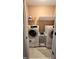Convenient laundry room with washer, dryer, and shelving at 1175 Grassy Oat Ln, Lawrenceville, GA 30045
