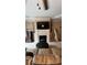 Relaxing living room featuring a corner fireplace and built-in shelving at 1175 Grassy Oat Ln, Lawrenceville, GA 30045
