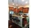 Modern kitchen with wood cabinets, granite countertops, and stainless steel appliances at 1175 Grassy Oat Ln, Lawrenceville, GA 30045