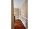 Upstairs hallway with hardwood floors, wainscoting, and crown molding at 1175 Grassy Oat Ln, Lawrenceville, GA 30045