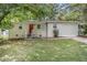 Ranch-style home with red front door and attached garage at 2623 Rex Sw Ave, Atlanta, GA 30331