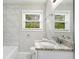 Clean bathroom with granite countertop, white cabinets, and a bathtub at 2623 Rex Sw Ave, Atlanta, GA 30331