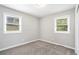 Bright bedroom with gray carpet, neutral walls, and two windows at 2623 Rex Sw Ave, Atlanta, GA 30331