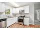 Modern kitchen with white cabinets, stainless steel appliances, and granite countertops at 2623 Rex Sw Ave, Atlanta, GA 30331