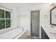 Bright bathroom with subway tile, soaking tub, and modern fixtures at 956 Glenwood Park Se Dr, Atlanta, GA 30316