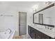Elegant bathroom with double vanity, large mirror, and soaking tub at 956 Glenwood Park Se Dr, Atlanta, GA 30316