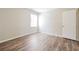 Bright bedroom with wood-look floors and a window at 3215 Highway 20 Se, Conyers, GA 30013