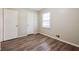 Simple bedroom with wood-look floors and double closets at 3215 Highway 20 Se, Conyers, GA 30013