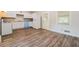 Efficient kitchen featuring white cabinets and vinyl flooring at 3215 Highway 20 Se, Conyers, GA 30013