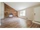 Spacious living room with brick fireplace and wood-look floors at 3215 Highway 20 Se, Conyers, GA 30013