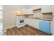 White kitchen with granite countertops and blue dishwasher at 3215 Highway 20 Se, Conyers, GA 30013