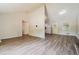 Open concept living room with kitchen views and wood-look floors at 3215 Highway 20 Se, Conyers, GA 30013