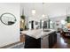 Open kitchen with island, stainless steel appliances, and hardwood floors at 360 Chambers St # 151, Woodstock, GA 30188