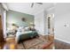 Spacious bedroom with hardwood floors, green accent wall, and walk-in closet at 360 Chambers St # 151, Woodstock, GA 30188