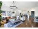 Open concept living room with hardwood floors, leather sectional sofa, and kitchen views at 360 Chambers St # 151, Woodstock, GA 30188