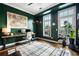 Home office with dark green walls, built-in desk, and large windows at 360 Chambers St # 151, Woodstock, GA 30188