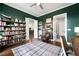 Spacious home office with built-in shelving and a view of the kitchen at 360 Chambers St # 151, Woodstock, GA 30188