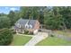 Two-story brick home with driveway and landscaped yard at 1500 Terminal Ct, Mcdonough, GA 30252