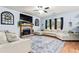 Spacious living room with L-shaped sectional sofa, fireplace, and wood floors at 1500 Terminal Ct, Mcdonough, GA 30252