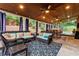 Large covered patio features wicker furniture and ceiling fan at 1500 Terminal Ct, Mcdonough, GA 30252