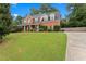Two-story brick home with American flag and landscaped yard at 1500 Terminal Ct, Mcdonough, GA 30252