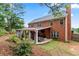 Brick home with covered patio, landscaping, and grilling area at 1500 Terminal Ct, Mcdonough, GA 30252