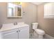 Clean bathroom with white vanity, toilet, and marble-look flooring at 3814 N Camp Creek Sw Pkwy, Atlanta, GA 30331