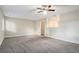 Bright living room with neutral walls and carpeting, open to kitchen at 4649 Big Valley Ct, Stone Mountain, GA 30083