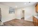 Eat-in kitchen with wood cabinets, granite countertops, and vinyl flooring at 4649 Big Valley Ct, Stone Mountain, GA 30083