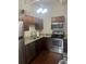 This kitchen features stainless steel appliances and wood cabinetry at 20 Marietta St # 9F, Atlanta, GA 30303