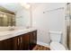 Updated bathroom with double vanity, shower, and tile flooring at 1868 Longdale Dr, Decatur, GA 30032