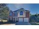 Two story brick home with a three-car garage at 12497 Lakeside Pkwy, Fayetteville, GA 30215