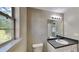 Simple bathroom with single vanity and updated flooring at 12497 Lakeside Pkwy, Fayetteville, GA 30215