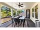 Covered porch with a dining set and ceiling fan, overlooking wooded backyard at 140 Discovery Lake Dr, Fayetteville, GA 30215