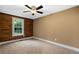 Spacious bedroom with wood-paneled accent wall and ceiling fan at 116 Southside Dr, Villa Rica, GA 30180