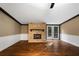 Spacious living room featuring hardwood floors, a stone fireplace, and access to a deck at 116 Southside Dr, Villa Rica, GA 30180