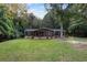 Single-story home with dark brown siding, stone accents, and a covered porch at 116 Southside Dr, Villa Rica, GA 30180