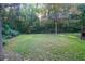 Wooded backyard with a large grassy area at 116 Southside Dr, Villa Rica, GA 30180