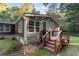 Single-story home with dark brown siding, stone accents, and a covered porch at 116 Southside Dr, Villa Rica, GA 30180