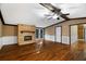 Living room with hardwood floors, stone fireplace and ceiling fan at 116 Southside Dr, Villa Rica, GA 30180