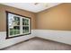 Well-lit bedroom with carpet flooring and a large window at 116 Southside Dr, Villa Rica, GA 30180