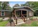 Single-story home with dark brown siding, stone accents, and a covered porch at 116 Southside Dr, Villa Rica, GA 30180