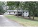 Single-story home with attached garage and large yard at 3219 Boulder Brook Dr, Lithonia, GA 30038