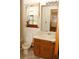 Simple bathroom with a toilet, sink, and window with curtains at 3219 Boulder Brook Dr, Lithonia, GA 30038