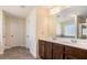 Double vanity bathroom with dark brown cabinets and a large mirror at 188 Sophie Cir, Locust Grove, GA 30248