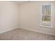 Simple bedroom with neutral walls, carpet flooring, and a window with blinds at 188 Sophie Cir, Locust Grove, GA 30248