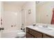 Clean bathroom with tub and shower combo, vanity with dark brown cabinets, and a mirror at 188 Sophie Cir, Locust Grove, GA 30248