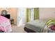 Cozy bedroom with a bed, window with curtains, and a play tent at 188 Sophie Cir, Locust Grove, GA 30248