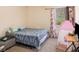 Charming bedroom with a double bed, window with curtains, and a trundle bed at 188 Sophie Cir, Locust Grove, GA 30248